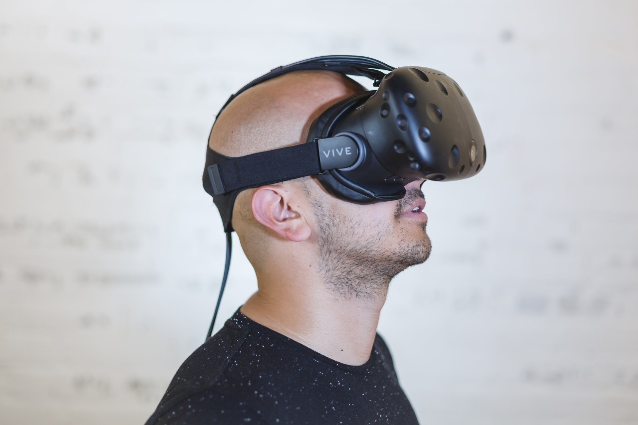 A man wearing a virtual reality headset enjoying Perfect Shot Virtual Reality and Gun Simulator